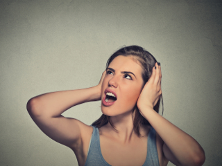 Woman unhappy covering ears